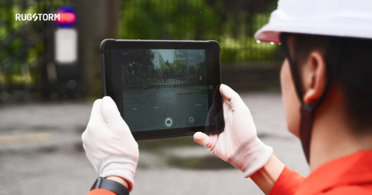 a worker using rugged tablet to filming